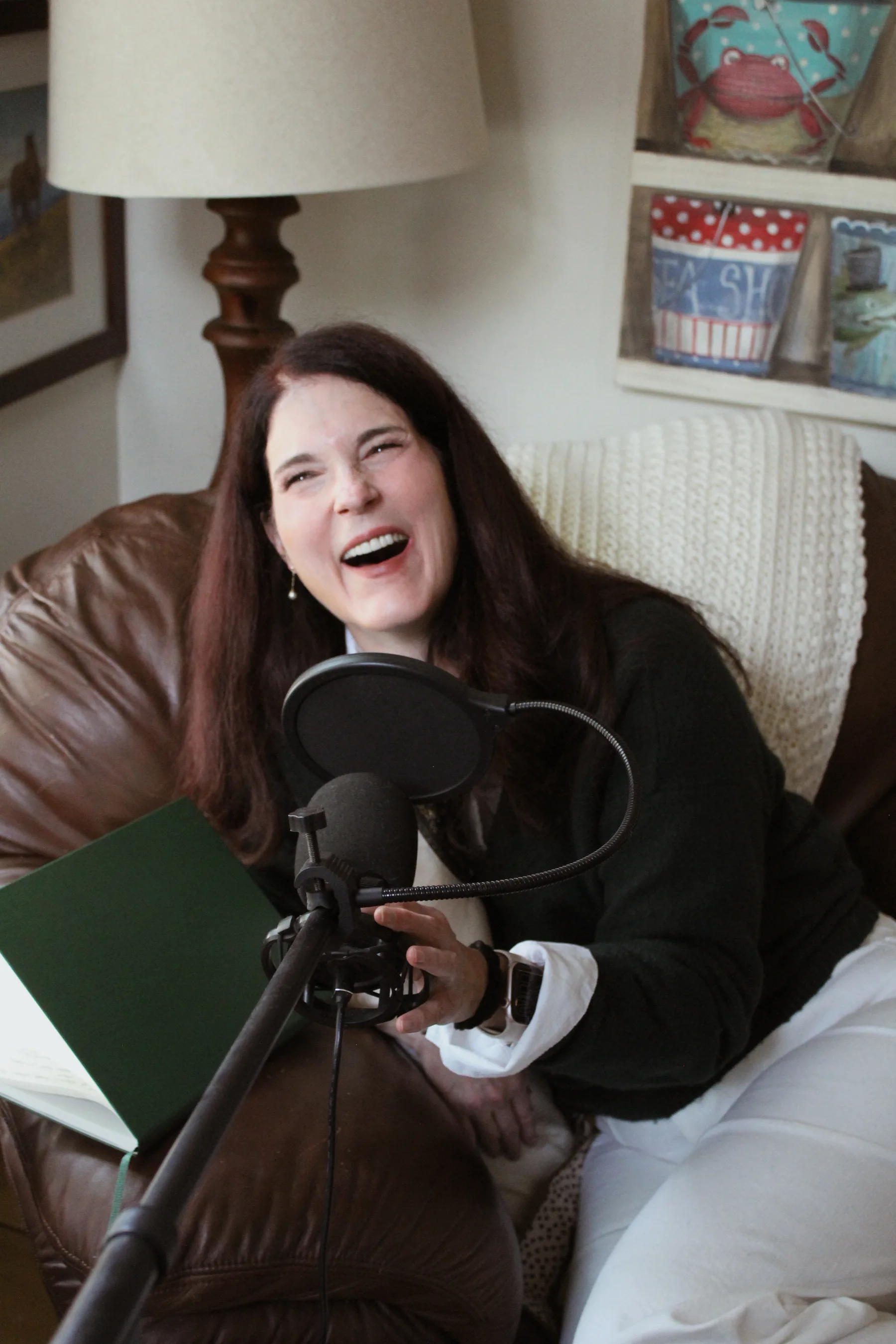 Abbie laughing during a conversation at a microphone