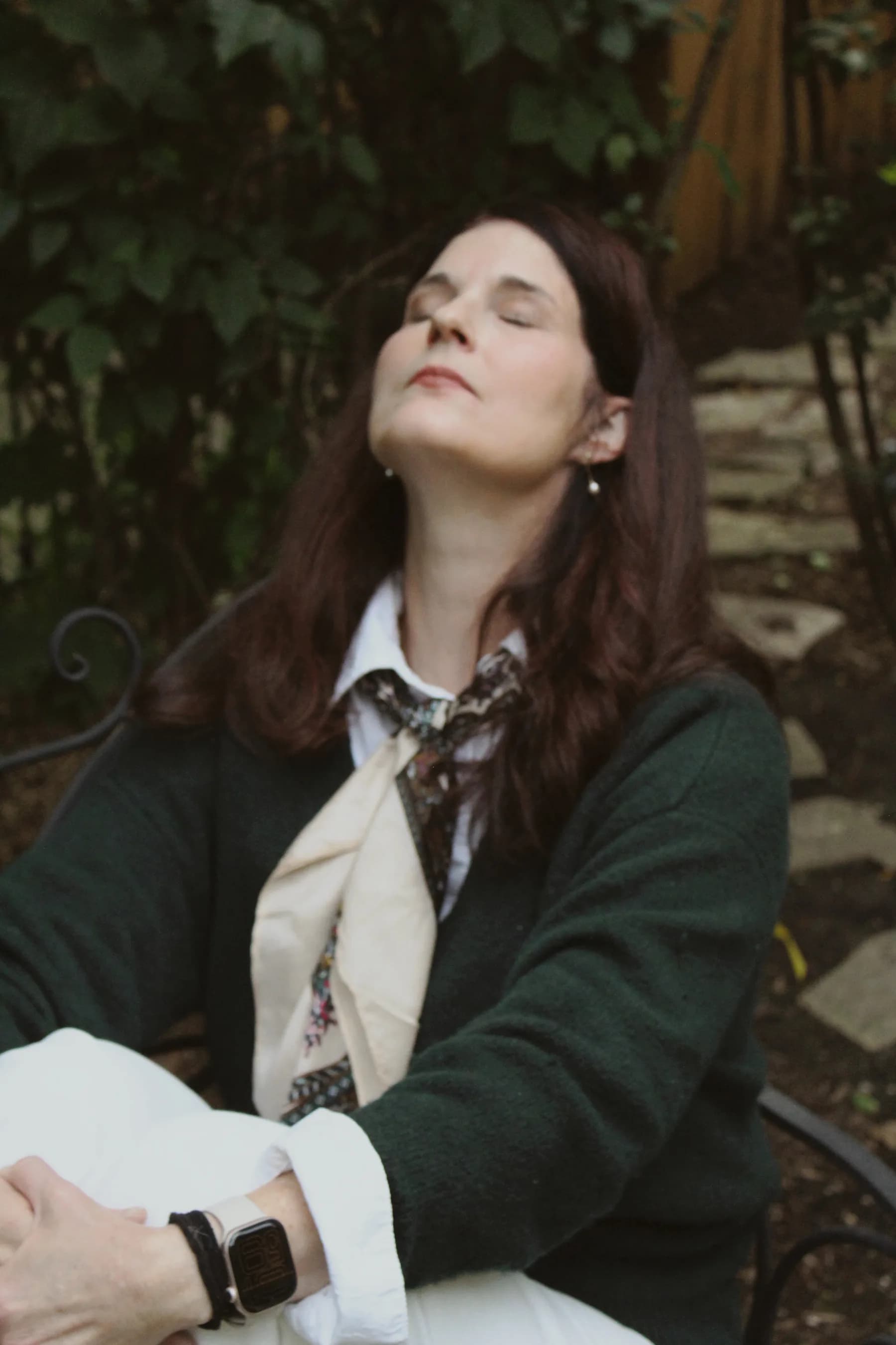 Abbie seated with her eyes closed